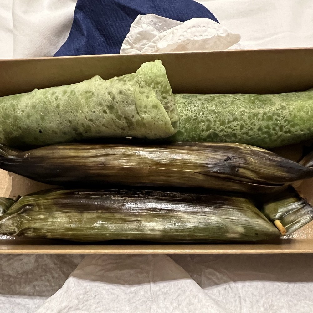 Putera Puteri - Kueh dadar (pandan flavoured crepe with sweet coconut filling). Glutinous rice filled with dried shrimp wrapped in banana leaf - Malaysian Near Me - London, XGL Putera Puteri - Kueh dadar (pandan flavoured crepe with sweet coconut filling). Glutinous rice filled with dried shrimp wrapped in banana leaf - Malaysian Near Me - London, XGL