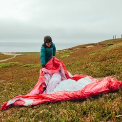 Carefully laying out the paraglider for launch.