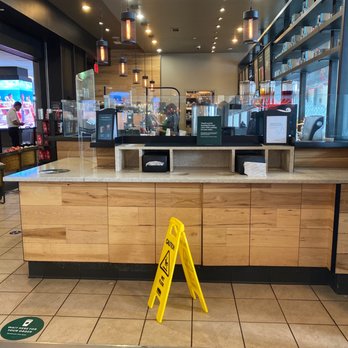 Starbucks - a yellow caution sign in a coffee shop - Coffee & Tea Near Me - Philadelphia, Pennsylvania Starbucks - a yellow caution sign in a coffee shop - Coffee & Tea Near Me - Philadelphia, Pennsylvania