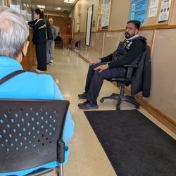 Service Ontario - This security man needed a rest. He opens the door to let folks outside know what number has been called and more.