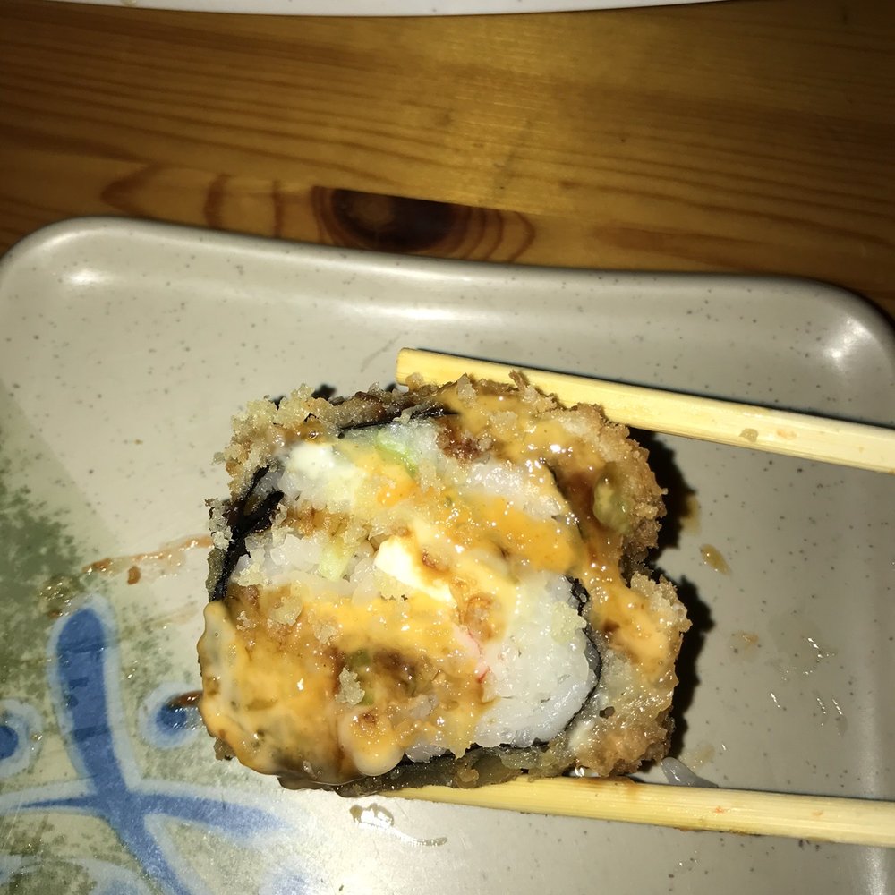 Umi Sushi - a close up of a sushi with chopsticks - Japanese Near Me - Shelby Township, Michigan Umi Sushi - a close up of a sushi with chopsticks - Japanese Near Me - Shelby Township, Michigan