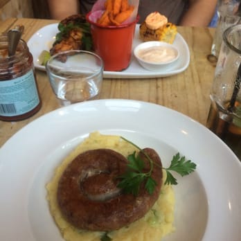 Bill's - Cumberland Sausage on potato Rosti in foreground - I think other plate is steak with excellent sweet potato fries and corn - British Near Me - Brighton, BNH