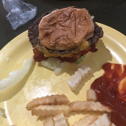 a hamburger and fries on a yellow plate a hamburger and fries on a yellow plate