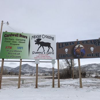 Moose Crossing Sweets & Gifts - three signs in the snow - Coffee & Tea Near Me - Cardwell, Montana Moose Crossing Sweets & Gifts - three signs in the snow - Coffee & Tea Near Me - Cardwell, Montana