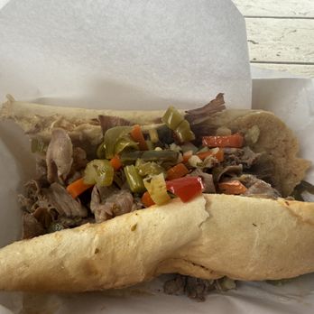 Dazzos Chicago Style Eatery - Italian beef with a bite taken out - Hot Dogs Near Me - Wikieup, Arizona