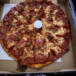 Cold, oddly cut sausage and pepperoni pizza Cold, oddly cut sausage and pepperoni pizza