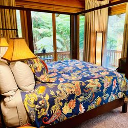 At the Crater's Edge - Plush, king size beds surrounded by huge sliding glass doors to a private balcony make it feel like your very own luxury tree house.