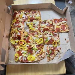 Domino's Pizza - How I received my pizza, looks like some pieces are missing but they are under Meath the others.