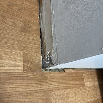 Dann Dolce Painting - above floorboard, which wasn't painted fully either, lack of patchwork uneven, painting, and incomplete - Painters Near Me