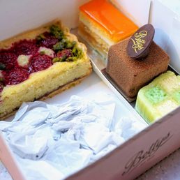 Raspberry Frangipane Slice (£3.50). Afternoon Tea Pâtisserie Selection: coconut & lime battenberg, orange slice, and chocolate cake (£5.50). Raspberry Frangipane Slice (£3.50). Afternoon Tea Pâtisserie Selection: coconut & lime battenberg, orange slice, and chocolate cake (£5.50).