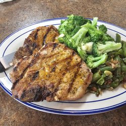 Two cajun pork chop supper with green beans and broccoli