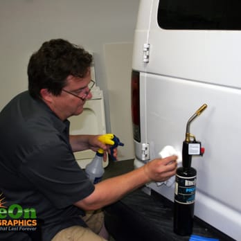 Shine On Signs and Graphics - Production manager working on vehicle prep for client's vinyl wrap advertising - Signmaking Near Me - Renton, Washington Shine On Signs and Graphics - Production manager working on vehicle prep for client's vinyl wrap advertising - Signmaking Near Me - Renton, Washington