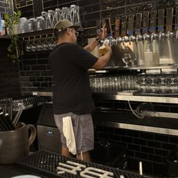 Bartender preparing the boot of beer. Bartender preparing the boot of beer.