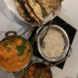 Punjabi Kitchen - Chicken Tikka Masala Dinner (the bright orange one on left) and Chicken Pishori Dinner (dark, oily curry on bottom) with some Garlic Naan