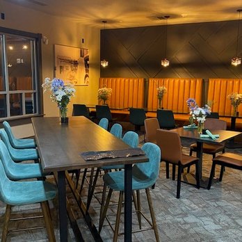 The Refinery - a restaurant with a long table and blue chairs - Breakfast & Brunch Near Me - Casper, Wyoming