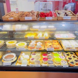 Deli case of tarts, pies, and croissants. Deli case of tarts, pies, and croissants.
