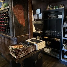 a wine shop with wine bottles and wine glasses a wine shop with wine bottles and wine glasses