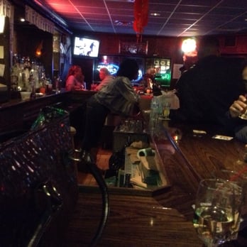 Henry Wok - a man sitting at a bar - Chinese Near Me - Jersey City, New Jersey
