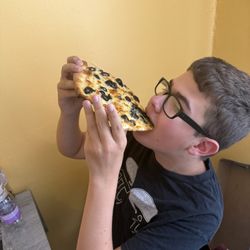 Observe the teenage boy: He ate 2 pieces! What an incredible feat!