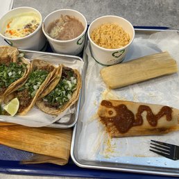 Tacos, chicken and pork tamales, rice, beans, chori-queso Tacos, chicken and pork tamales, rice, beans, chori-queso