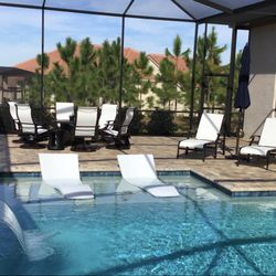 Leaders Furniture of Spring Hill - Fire table with 6 high back swivel rockers, 2 chaise loungers, and 2 in pool loungers.