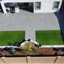 PMC Lawn Care and Landscape Services - Paver, artificial grass, and planter/ wall on stacked stone.