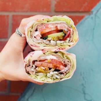 Jimmy John's - a person holding a sandwich - Delis Near Me - Canton, Michigan