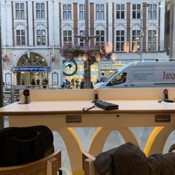 McDonald's - Great view of High Street Kensington tube.  FYI these counter tables have charging stations!