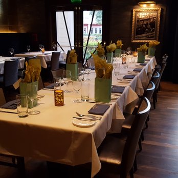 Flying Fish - The table set up for a large party. Bags on the table were added by me upon arrival, but the rest of the place setting was already there. - Seafood Near Me - Orlando, Florida