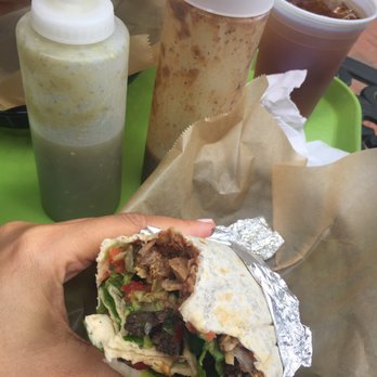 Highlands Burrito - a hand holding a burrito - Mexican Near Me - Highlands, North Carolina Highlands Burrito - a hand holding a burrito - Mexican Near Me - Highlands, North Carolina