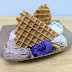 Andia's Ice Cream - Sampler Flight. $7.75. Baklava, Cake Batter, Oreo Latte, Ube, Malted Twix, Rose Pistachio. Topped with 2 waffle wedges.