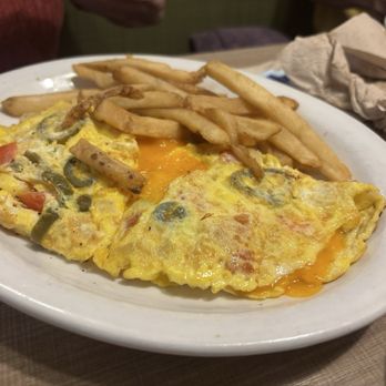 Starlight Diner - Mexican Omelette - A breakfast plate featuring a vegetable omelette with tomatoes, mushrooms, and cheese, served with French fries. - Diners Near Me - Hanover, Pennsylvania