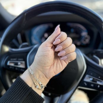 Art Me Nails Studio - Pink nails against steering wheel. - Nail Salons Near Me - Chicago, Illinois