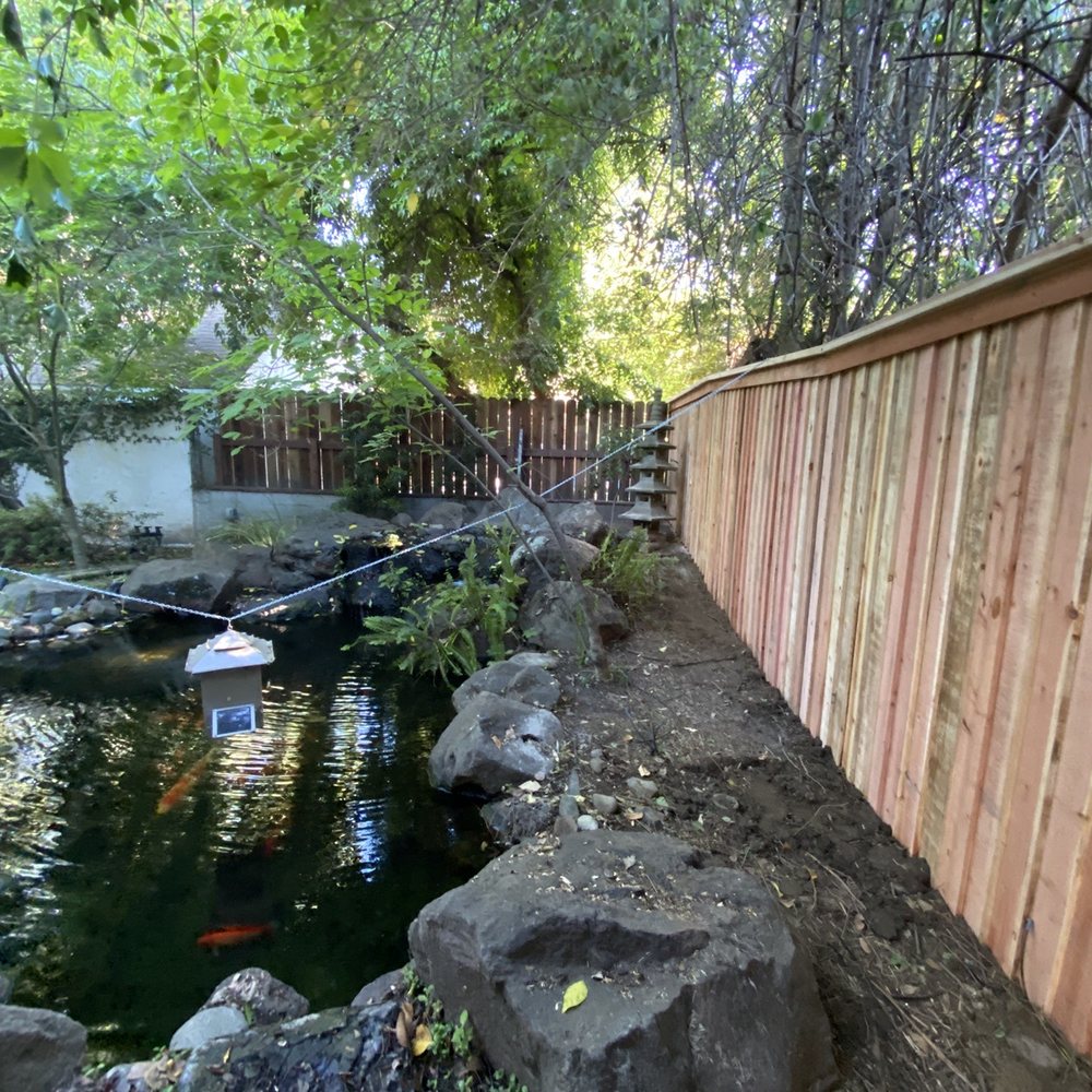 The fence slopes up to match the grade by the koi pond. The fence slopes up to match the grade by the koi pond.