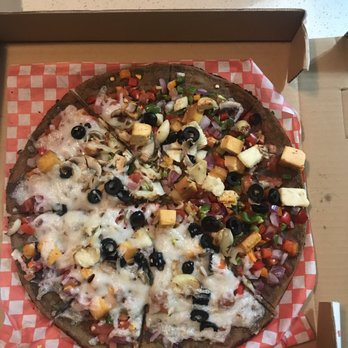 Caveman Cafe - Vegan pizza half with cashew cheese and half with home made cheeze - Organic Stores Near Me - Vancouver, British Columbia