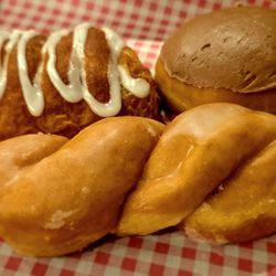 Clockwise from upper left: Strawberry Croissant; Custard; and Glazed Twist