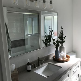 RCS Builders - a bathroom with a sink and mirror - General Contractors Near Me