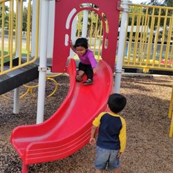 Whitendale Infant/Toddler Center - Sliding on the 2 year old playground