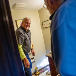 Nixco Plumbing - Service technician talking to customer in home