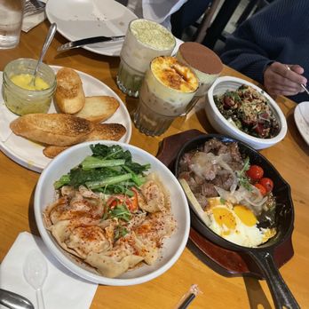 NEP Cafe - left to right: the dao, Szechuan spicy dumpling-noodle, banh mi chao, and crispy Brussels sprouts. - Breakfast & Brunch Near Me - Irvine, California NEP Cafe - left to right: the dao, Szechuan spicy dumpling-noodle, banh mi chao, and crispy Brussels sprouts. - Breakfast & Brunch Near Me - Irvine, California