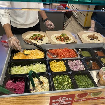 Quesada Burritos and Tacos - a person preparing food - Mexican Near Me - Vancouver, British Columbia Quesada Burritos and Tacos - a person preparing food - Mexican Near Me - Vancouver, British Columbia