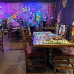 Just one shot of the area of the restaurant where we sat. The whole restaurant has great art work from the walls to the tables and seating. Just one shot of the area of the restaurant where we sat. The whole restaurant has great art work from the walls to the tables and seating.