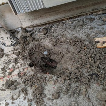 GS Floor Design - The nail through the pipe exposed after digging up the concrete subfloor. - Flooring Near Me - Arlington Heights, Illinois GS Floor Design - The nail through the pipe exposed after digging up the concrete subfloor. - Flooring Near Me - Arlington Heights, Illinois