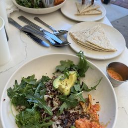 Two Mother Earth bowls one with Steak and other no meat. Pita bread on the side Two Mother Earth bowls one with Steak and other no meat. Pita bread on the side