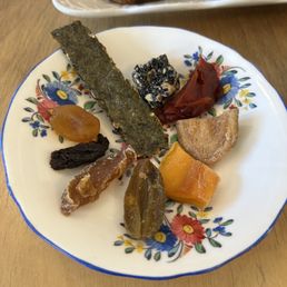 Assorted preserved fruits, sesame bite and toasted seaweed, part of Treat Yourself option.