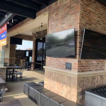 Trinity Technologies - Tv mount on brick wall & ceiling. Mackie surround sound speakers connected to mixer at Uncle Tony's Pizzeria in the city of North Hollywood - Home Theatre Installation Near Me