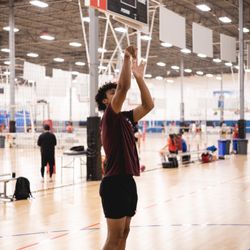 Coach Charleston showing trainees how to follow through on their jumper