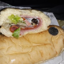 a sub sandwich with meat and lettuce