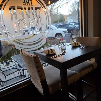 The River and Rail - A cozy, small table for two in a nook next to the window of the restaurant. - Southern Near Me - Roanoke, Virginia The River and Rail - A cozy, small table for two in a nook next to the window of the restaurant. - Southern Near Me - Roanoke, Virginia
