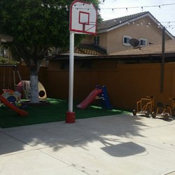 Guzman Family Child Care - Giant backyard with tricycles, a basketball court, swing sets, and a lot of room to run